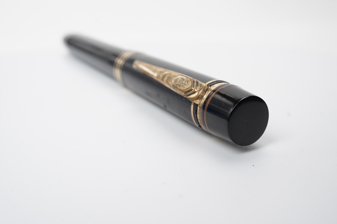A De la Rue Onoto piston fill fountain pen in large size with ornate cap banding and fitted with DLR Onoto No.5 14ct. nib